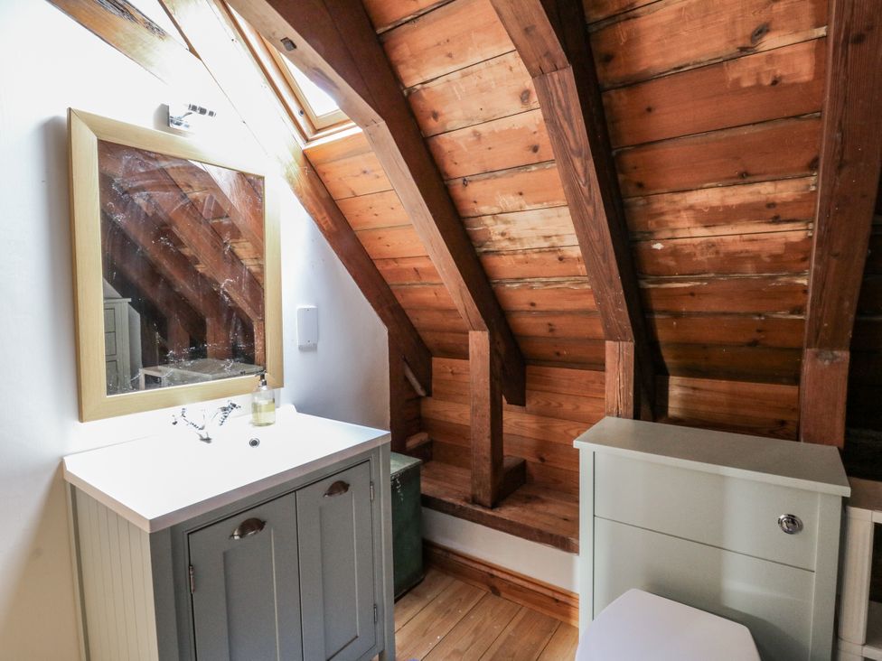 A bathroom with a sink and a mirror at Church Llygad Y Dyffryn Sarnau near Brynhoffnant