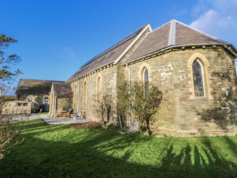 A church with a garden and trees at Church Llygad Y Dyffryn in Sarnau near Brynhoffnant