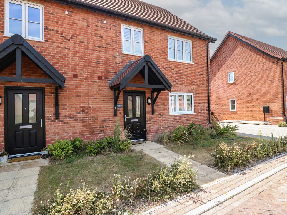 A front view of a house with pathways and gardens at Inishnee House Shotley Gate
