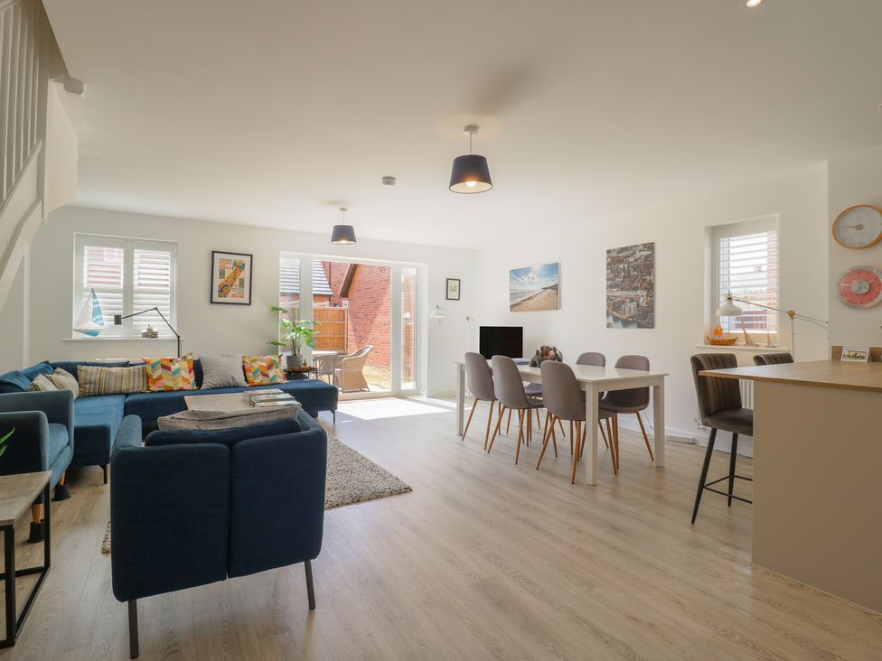 A living room with a sofa and dining area at Inishnee House in Shotley Gate