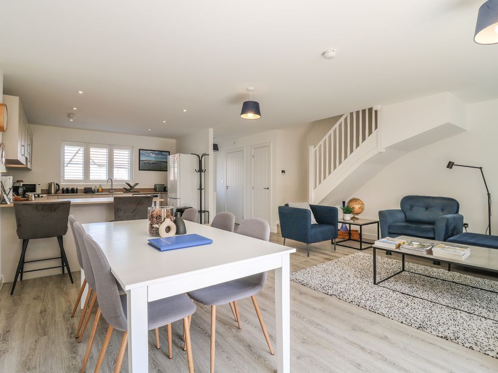 A living room with a dining area and kitchen at Inishnee House in Shotley Gate