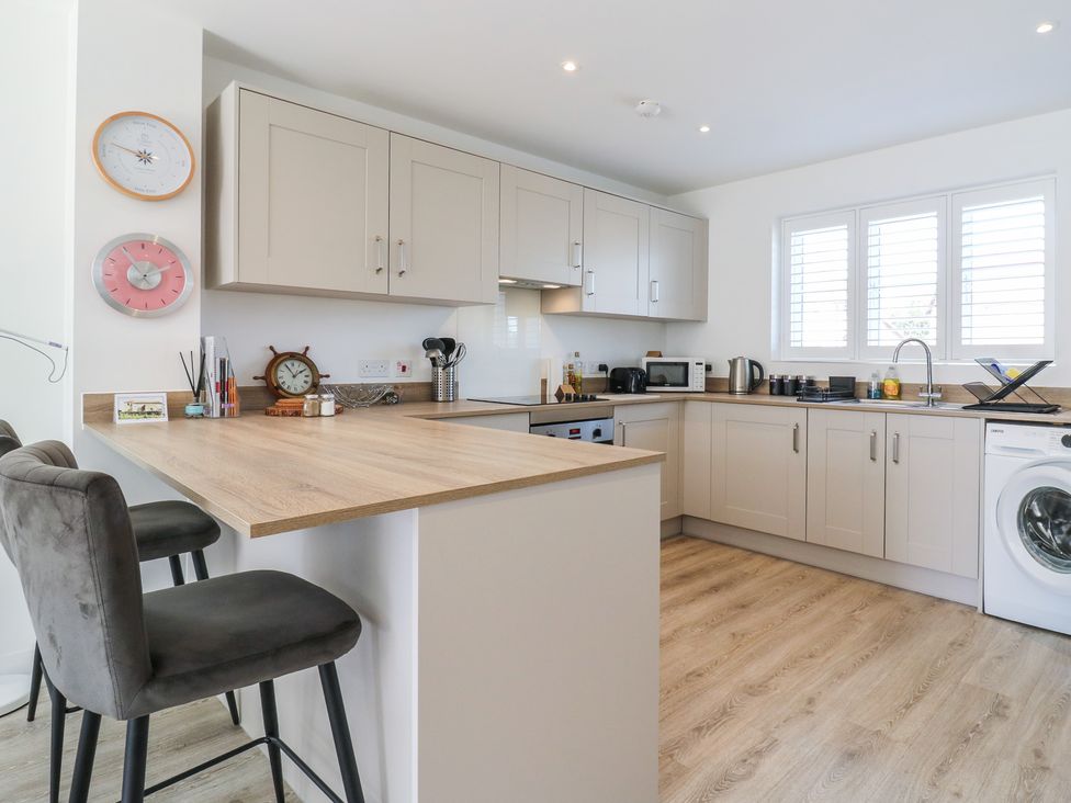 A kitchen with cabinets, sink, and appliances at Inishnee House in Shotley Gate