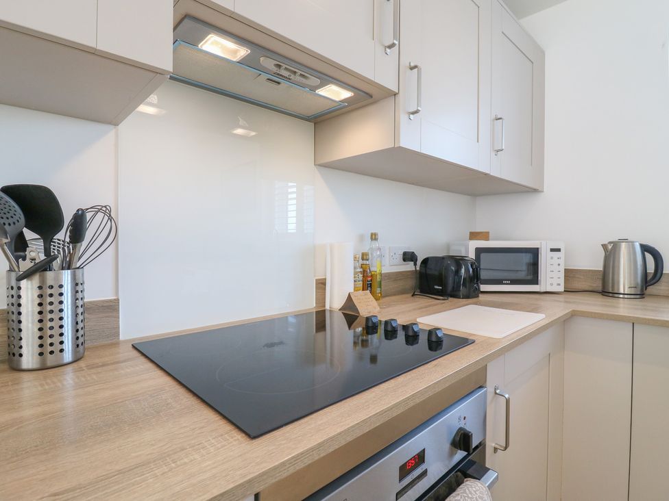 A kitchen with a cooktop, microwave, and kettle at Inishnee House, Shotley Gate