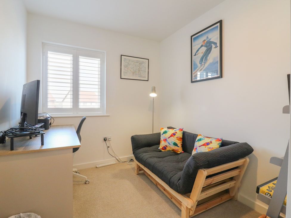 An office with a desk and a sofa at Inishnee House in Shotley Gate