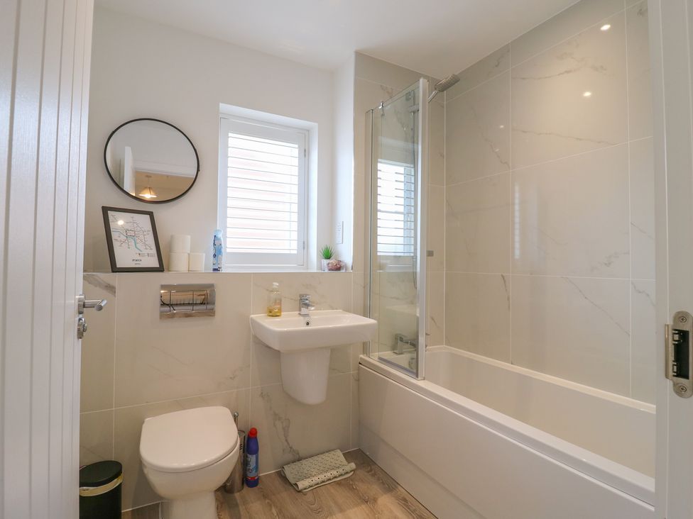 A bathroom with a sink, toilet, and bath at Inishnee House in Shotley Gate
