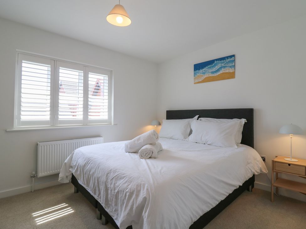 A bedroom with a bed and bedside table at Inishnee House in Shotley Gate