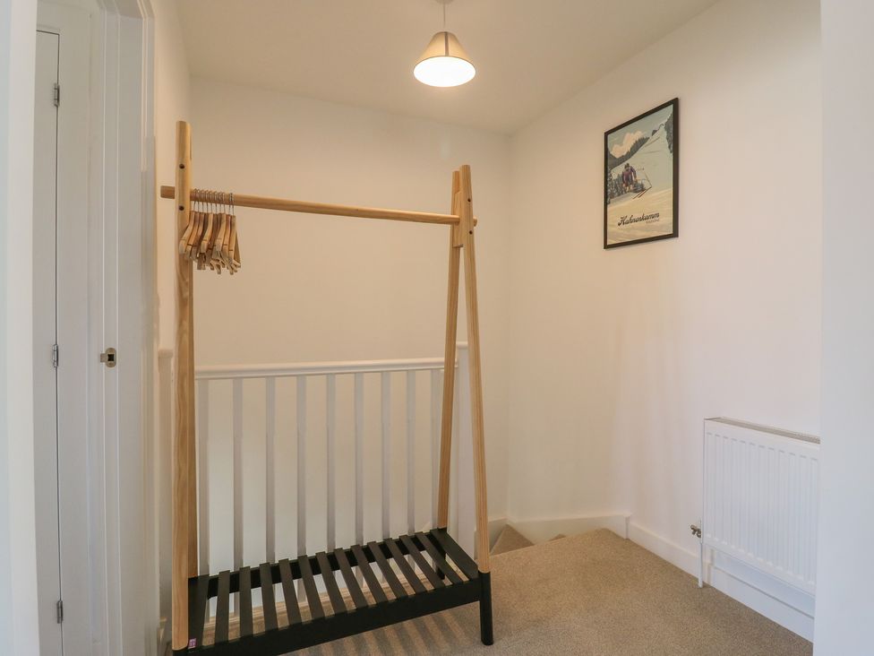 A hallway with a clothes rack and a radiator at Inishnee House in Shotley Gate