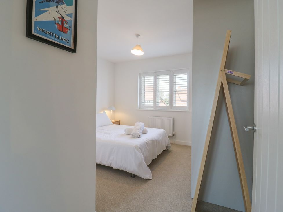 A bedroom with a bed and a lamp at Inishnee House in Shotley Gate