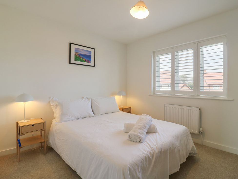 A bedroom with a bed and bedside tables at Inishnee House in Shotley Gate