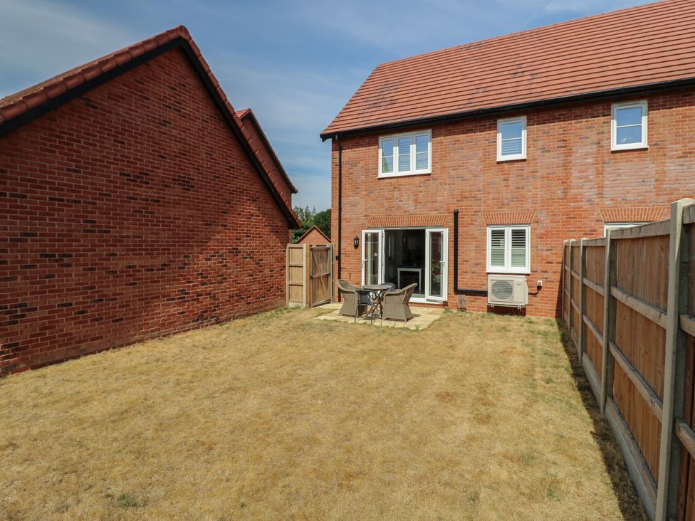 A garden with a patio table and chairs at Inishnee House in Shotley Gate