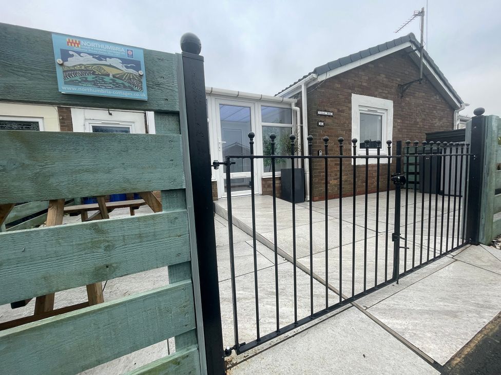 An outdoor area with a fence and gate at Villa Rose in Beadnell near Seahouses