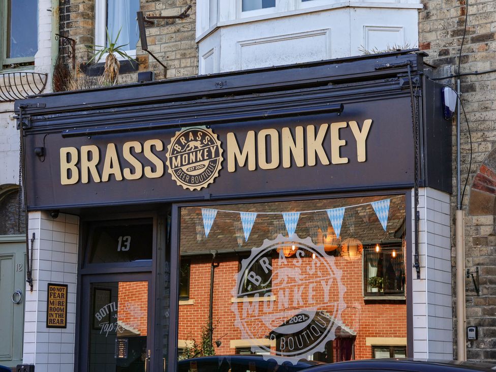 A sign of Brass Monkey Beer Boutique at 13 Street in Saltburn-By-The-Sea
