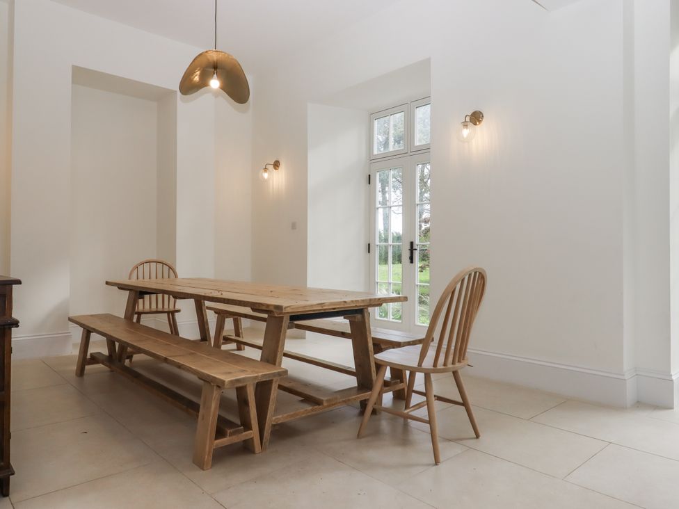 A dining room with a table and chairs at Alston Hall Battisborough Cross