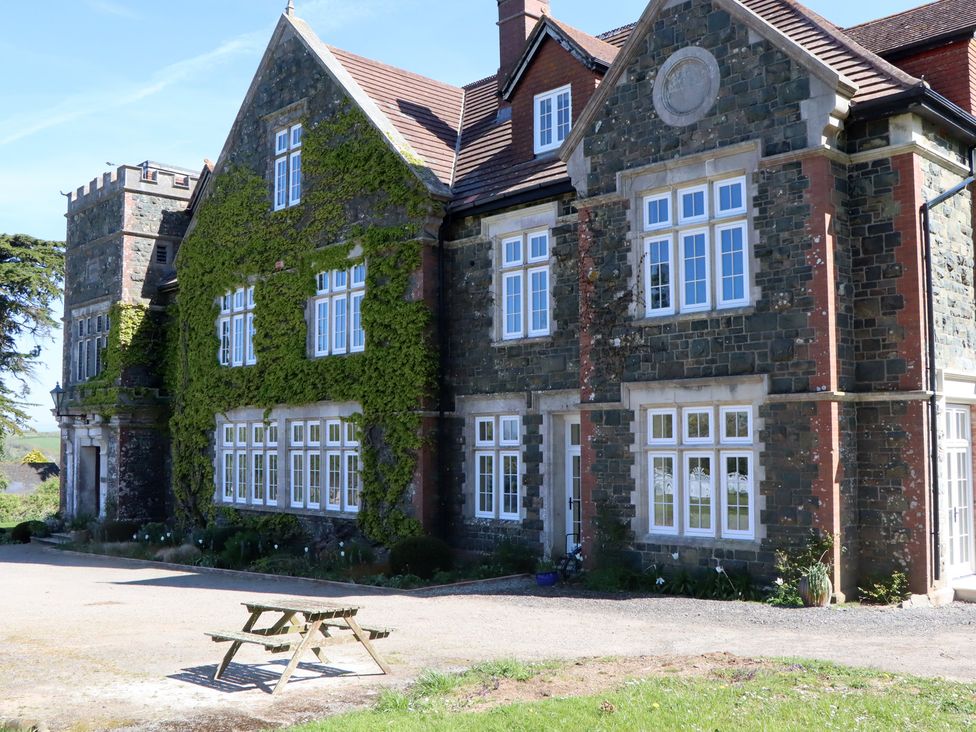 A house with large windows and a pathway at Alston Hall near Mothecombe Beach