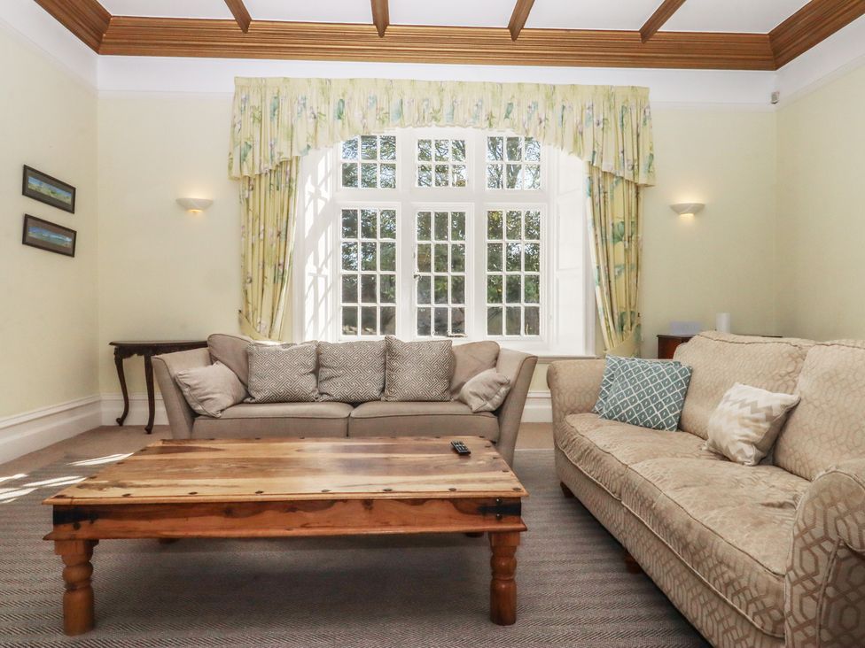 A living room with sofas and a coffee table at Alston Hall near Mothecombe Beach