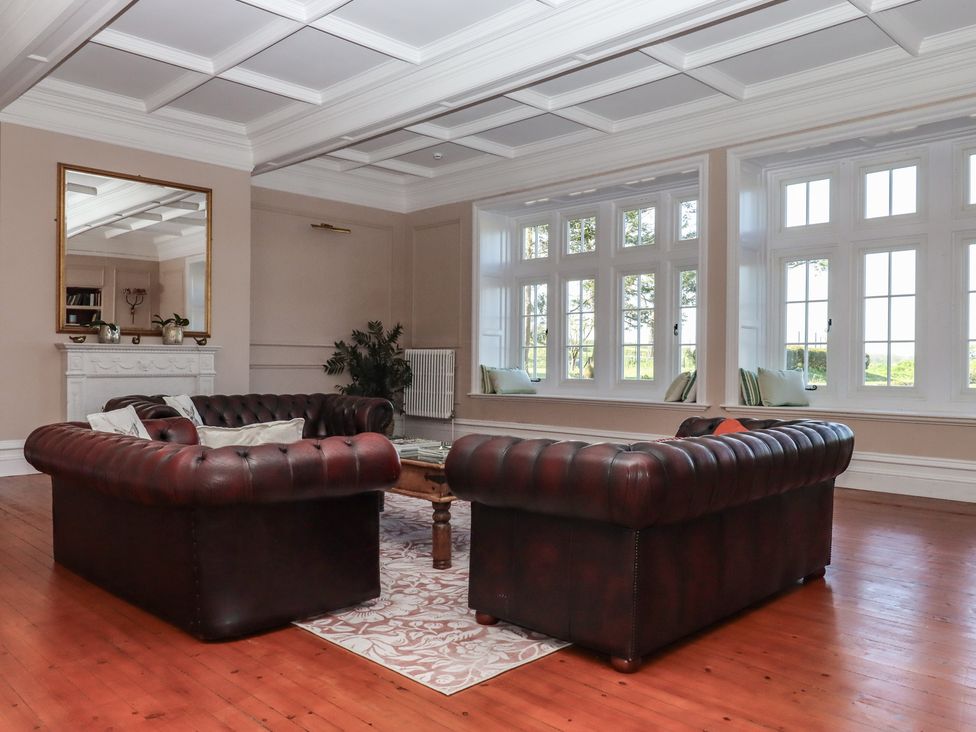 A living room with two sofas and a coffee table at Alston Hall near Mothecombe Beach