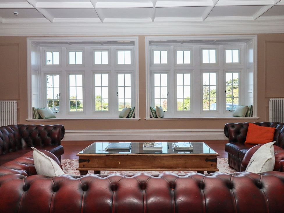 A living room with a sofa and coffee table at Alston Hall near Mothecombe Beach