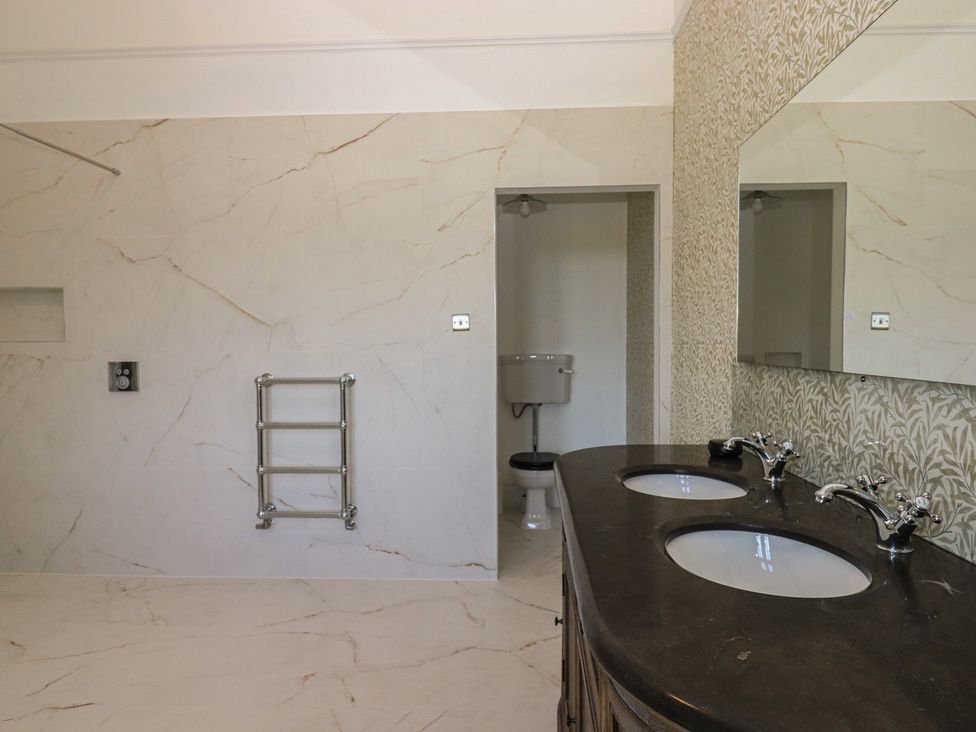 A bathroom with sinks and a toilet at Alston Hall near Mothecombe Beach