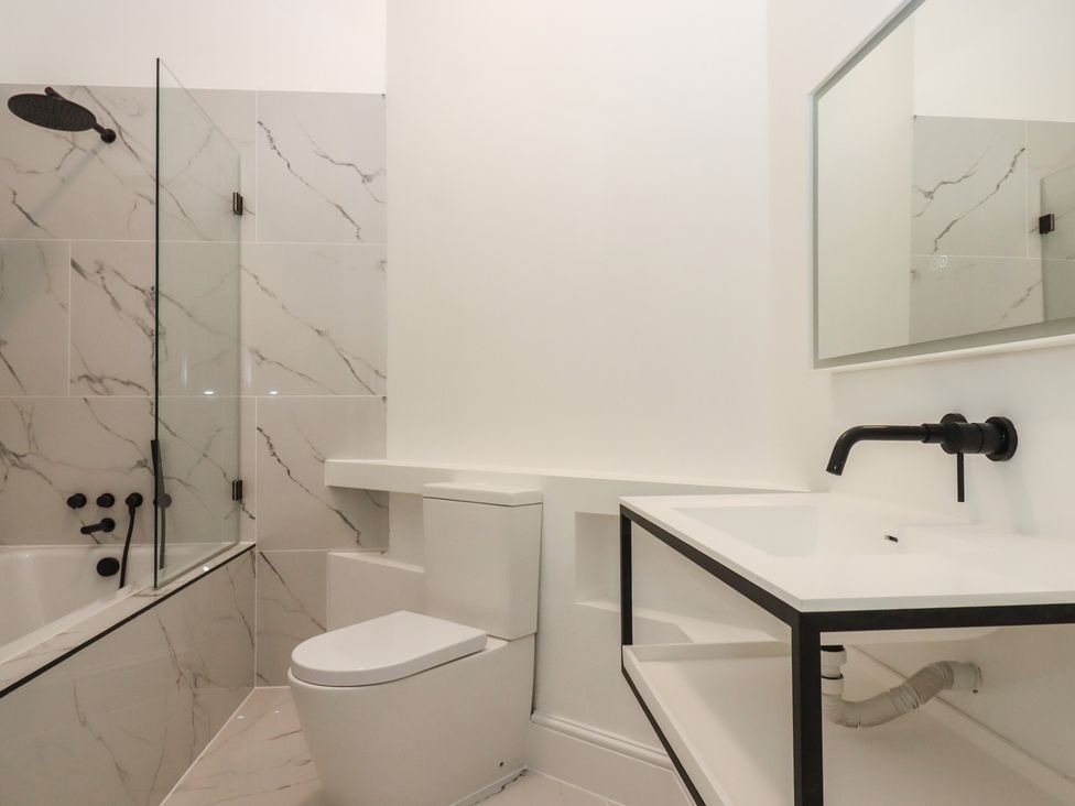 A bathroom with a shower, toilet, and sink at Alston Hall near Mothecombe Beach