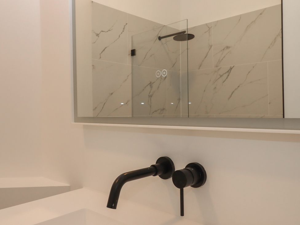 A bathroom with a shower and sink at Alston Hall near Mothecombe Beach