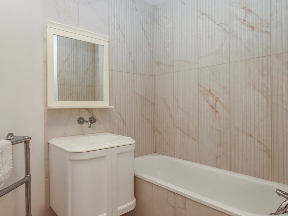 A bathroom with a sink and bath tub at Alston Hall near Mothecombe Beach