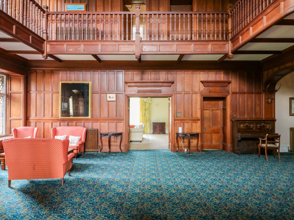A living room with sofas and a fireplace at Alston Hall near Mothecombe Beach