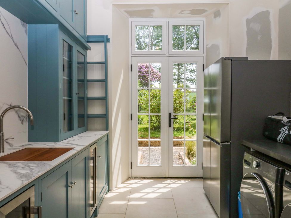 A kitchen with a sink and cabinets at Alston Hall near Mothecombe Beach