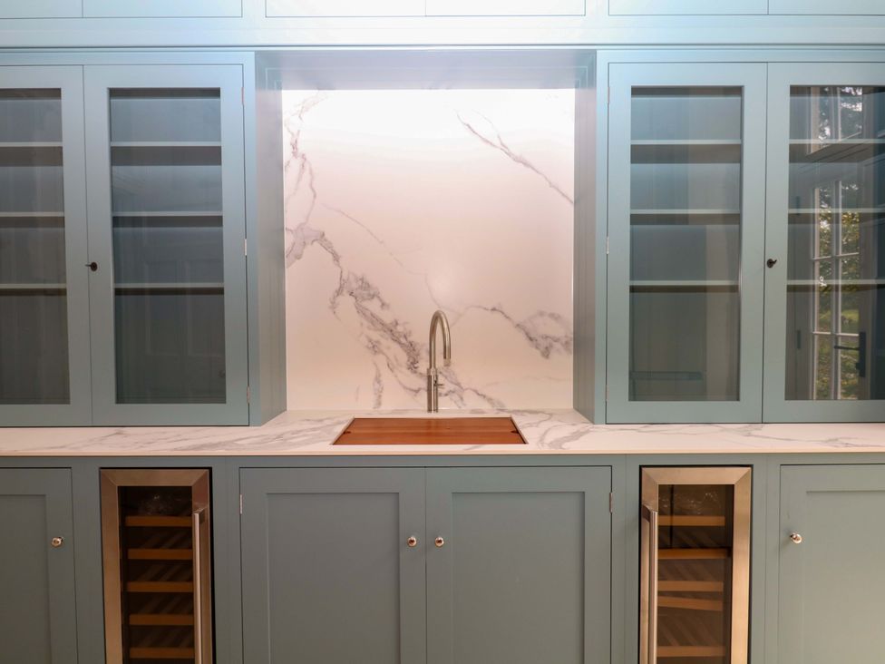 A kitchen with cabinets, sink, and countertop at Alston Hall near Mothecombe Beach