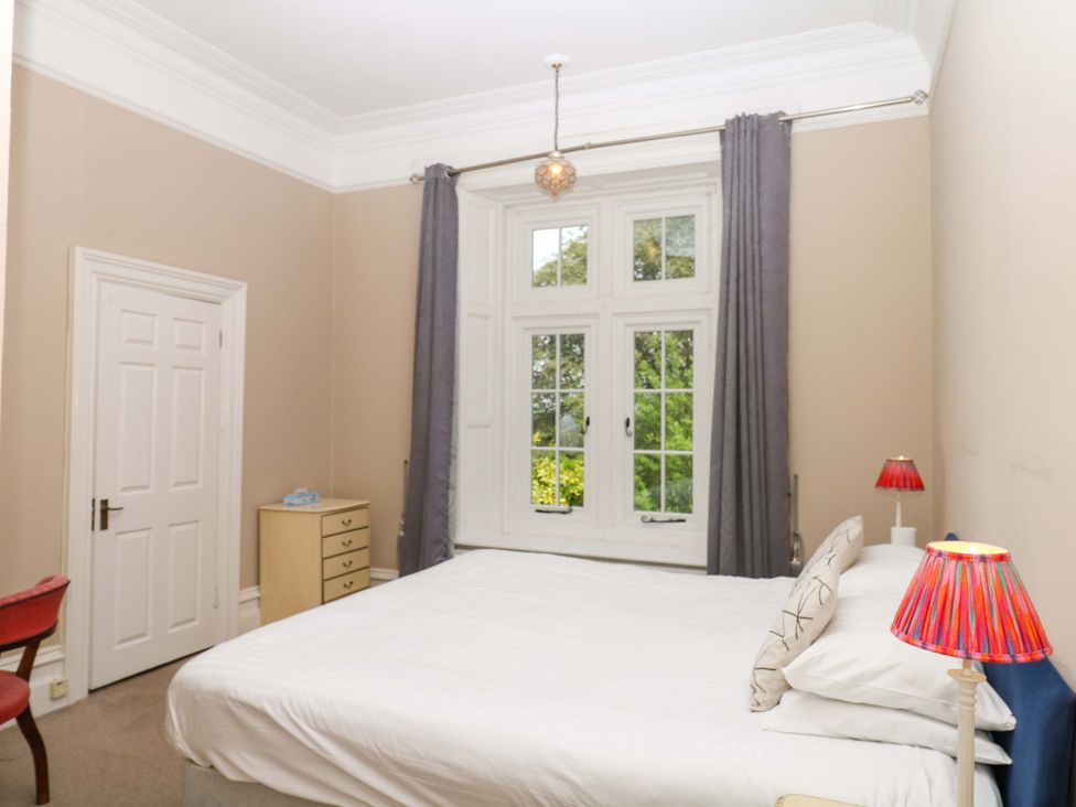 A bedroom with a bed and window at Alston Hall near Mothecombe Beach