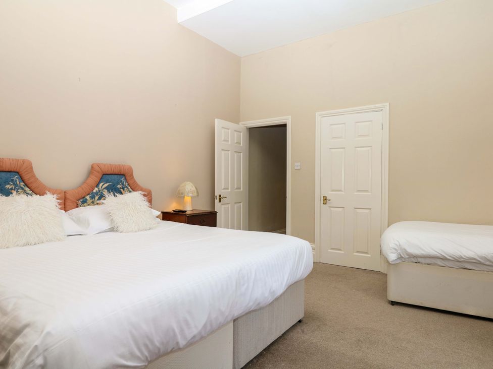A bedroom with a bed and a nightstand at Alston Hall near Mothecombe Beach