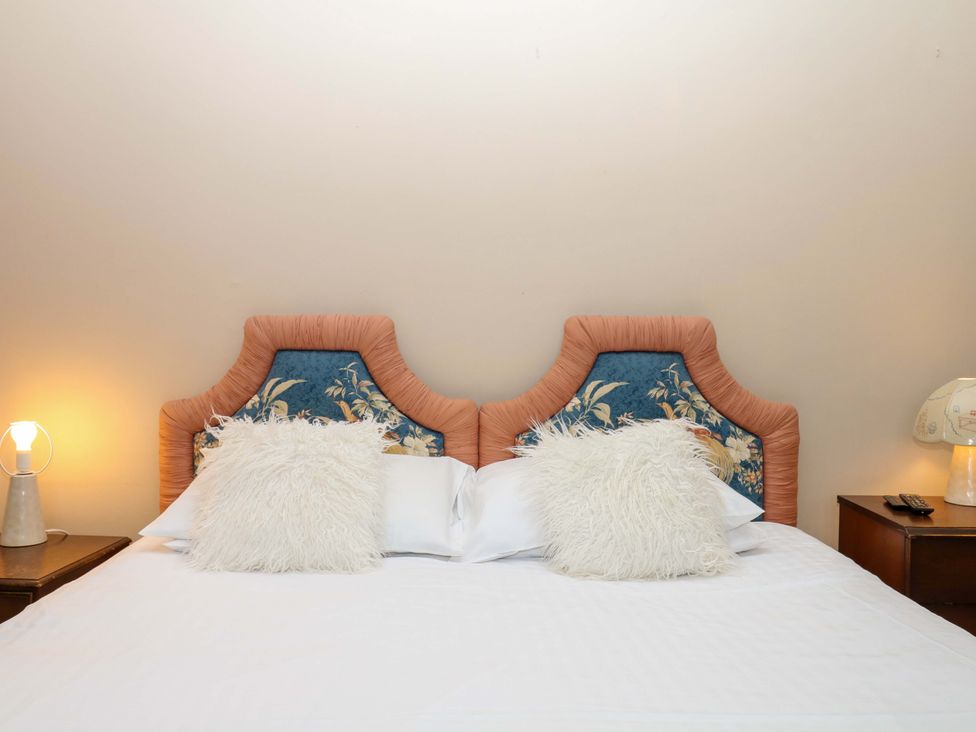 A bedroom with a bed and bedside table at Alston Hall near Mothecombe Beach