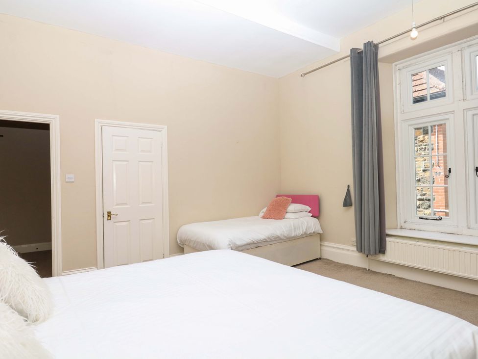 A bedroom with two beds and a window at Alston Hall near Mothecombe Beach