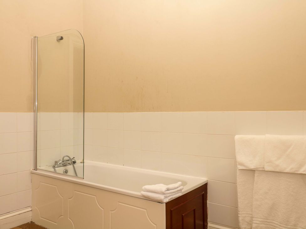 A bathroom with a bathtub and a towel at Alston Hall near Mothecombe Beach