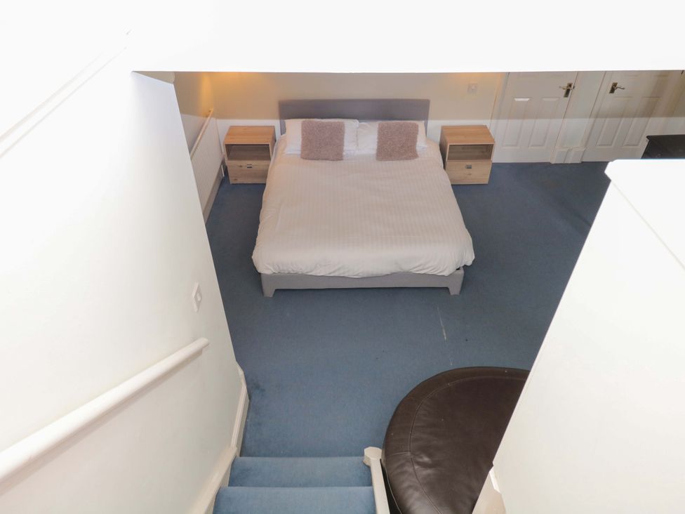 A bedroom with a bed and nightstands at Alston Hall near Mothecombe Beach