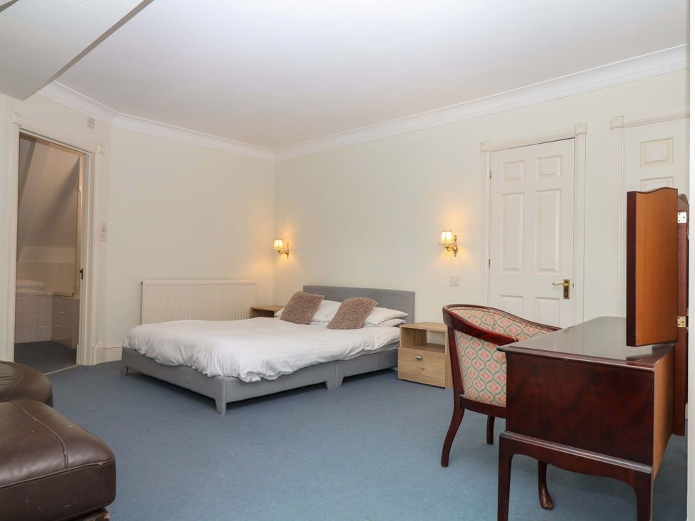 A bedroom with a bed and desk at Alston Hall near Mothecombe Beach