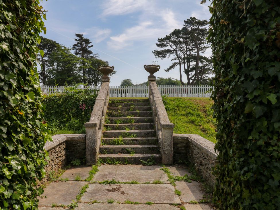Stairs leading to a fenced area with plants at Alston Hall near Mothecombe Beach