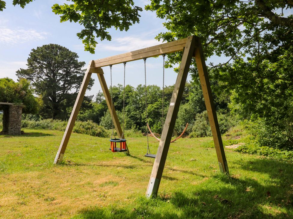 A swing set on grass at Alston Hall near Mothecombe Beach