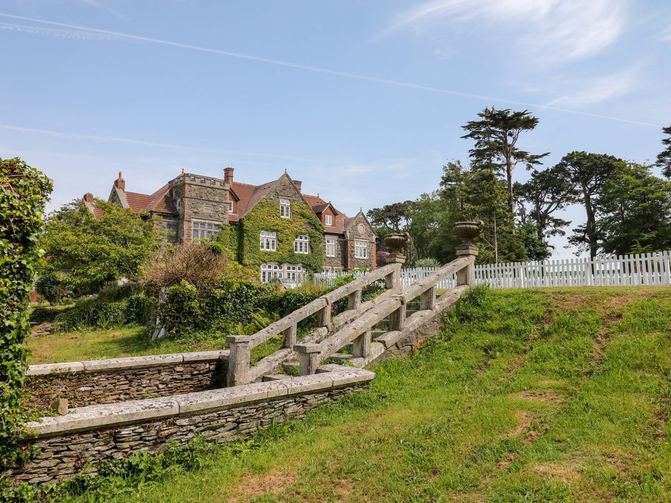 A stone house with garden and stairs at Alston Hall near Mothecombe Beach