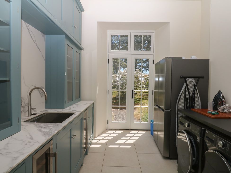A kitchen with a sink and refrigerator at Alston Hall near Mothecombe Beach