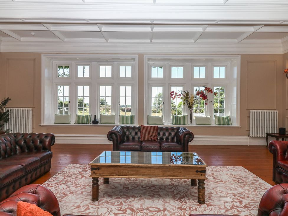 A living room with sofas and a coffee table at Alston Hall near Mothecombe Beach