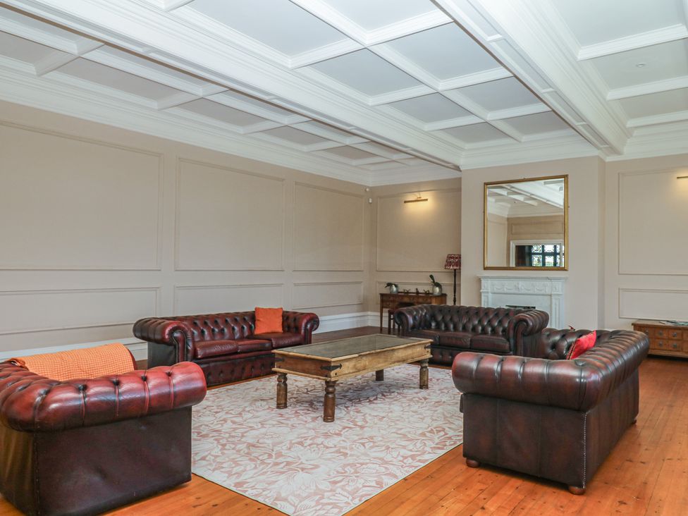 A living room with sofas and a coffee table at Alston Hall near Mothecombe Beach