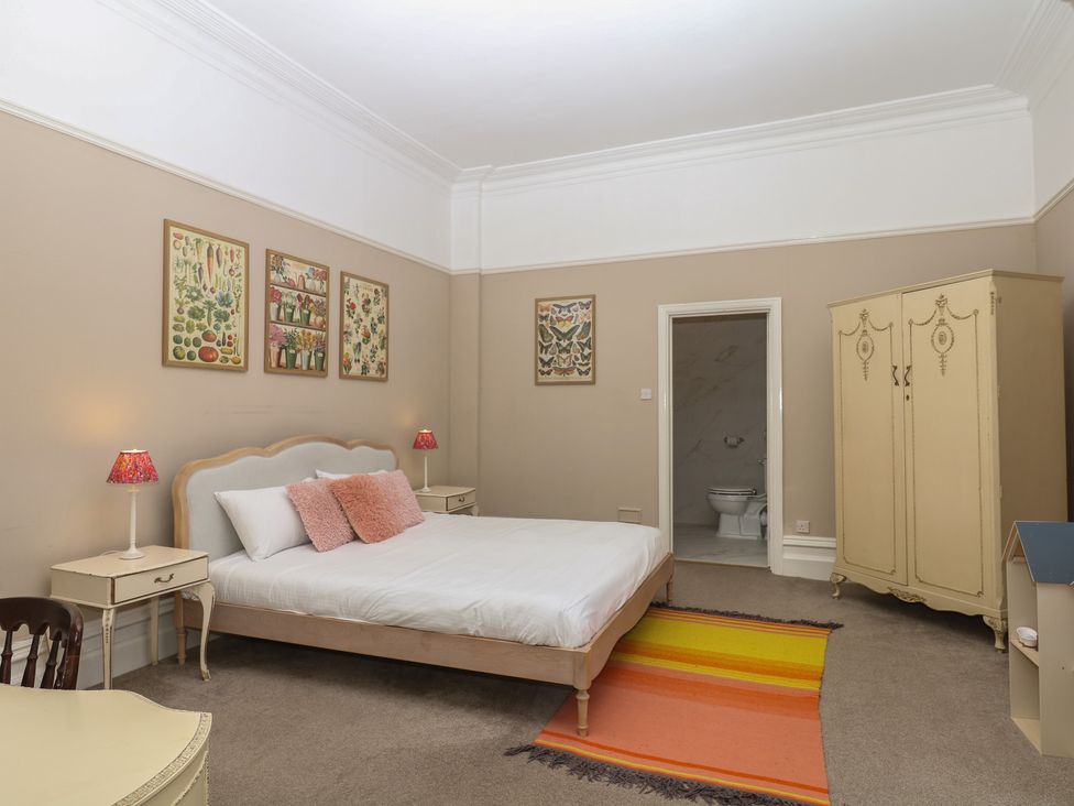 A bedroom with a bed and a wardrobe at Alston Hall near Mothecombe Beach