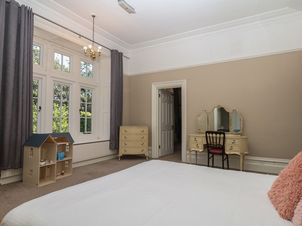 A bedroom with bed and furniture at Alston Hall near Mothecombe Beach