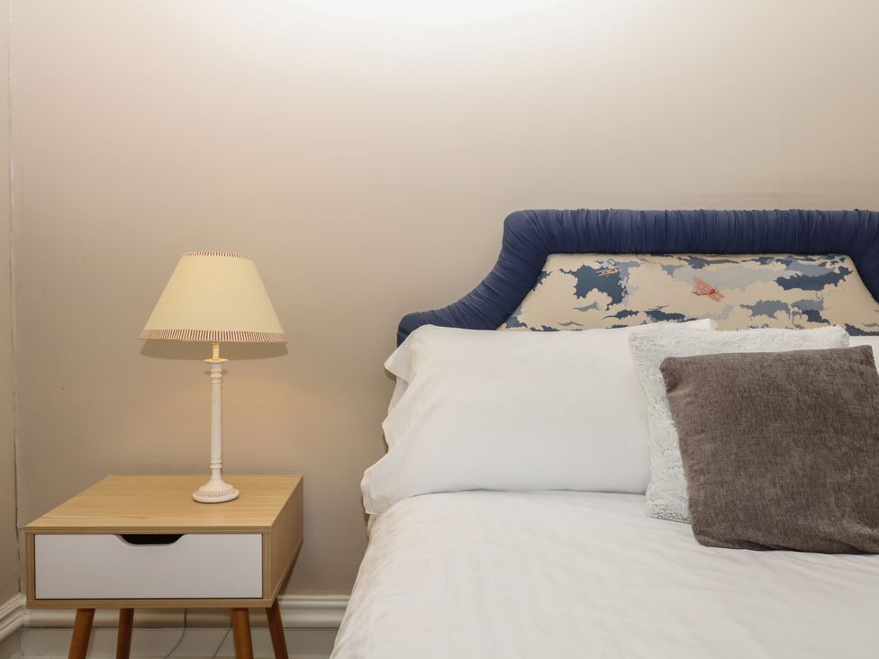 A bedroom with a bed and bedside lamp at Alston Hall near Mothecombe Beach