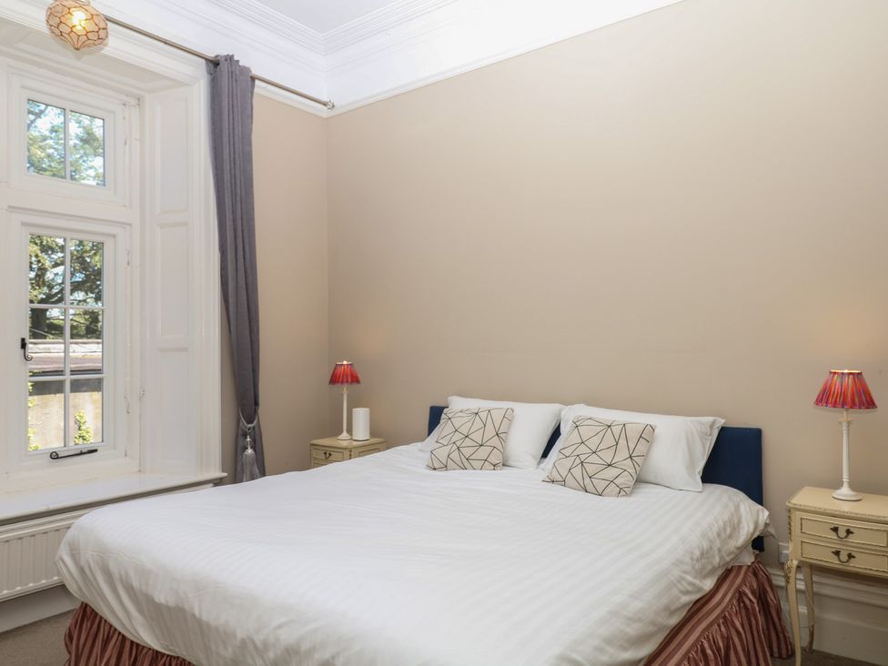 A bedroom with a bed and side tables at Alston Hall near Mothecombe Beach