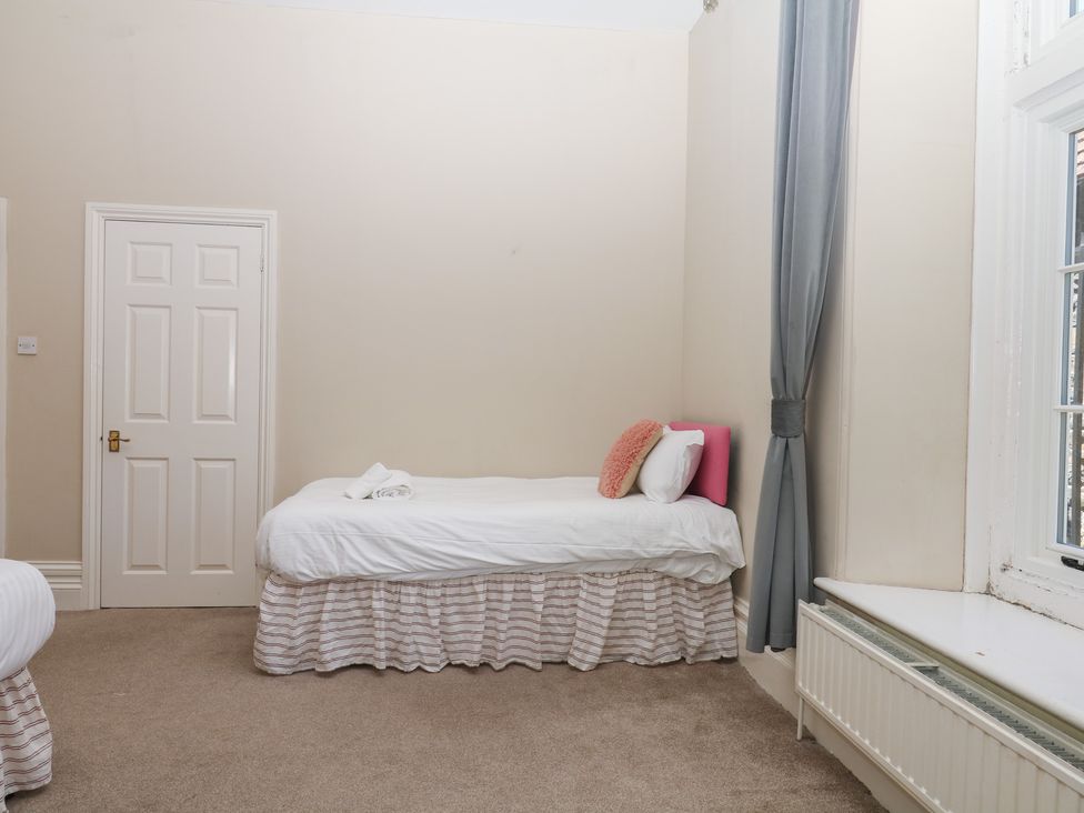 A bedroom with a bed and door at Alston Hall near Mothecombe Beach