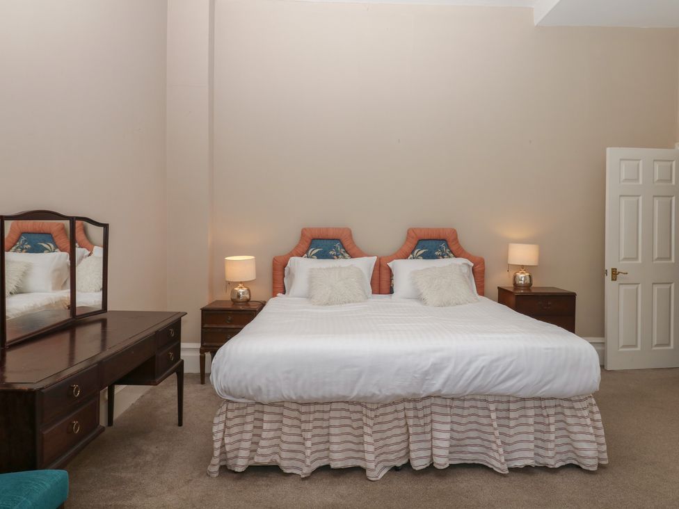 A bedroom with a double bed and a mirror at Alston Hall near Mothecombe Beach