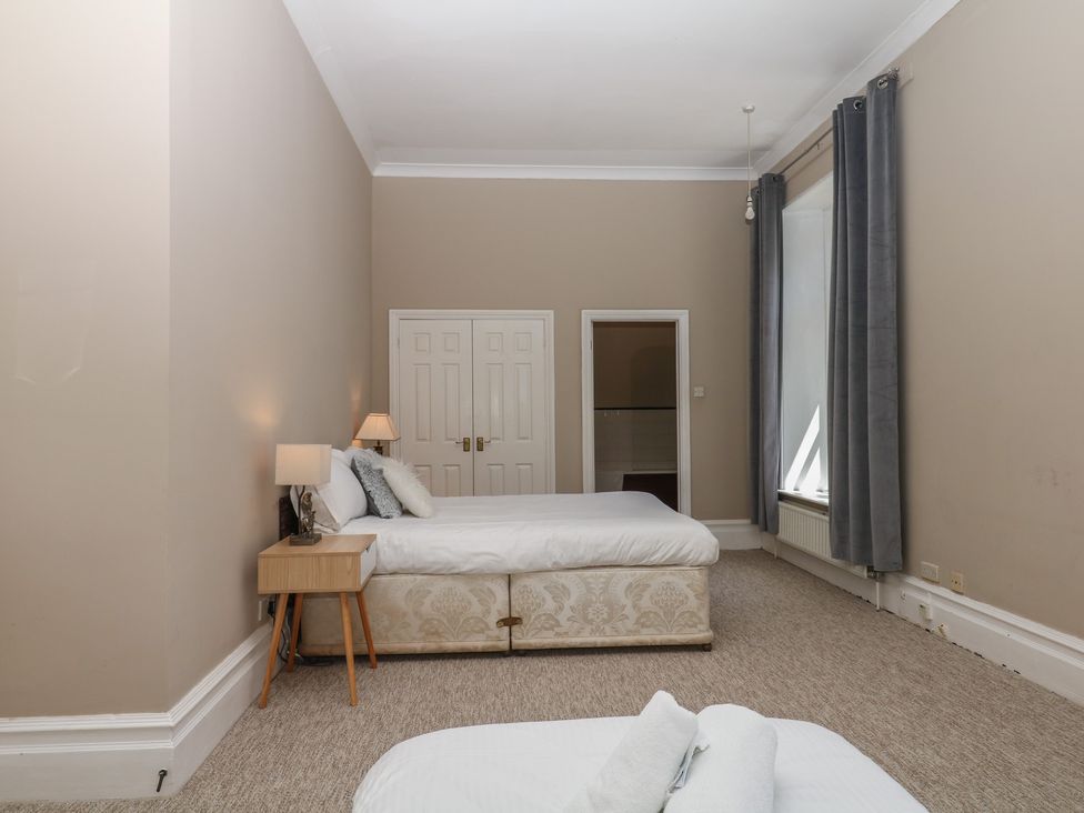 A bedroom with a bed and a nightstand at Alston Hall near Mothecombe Beach