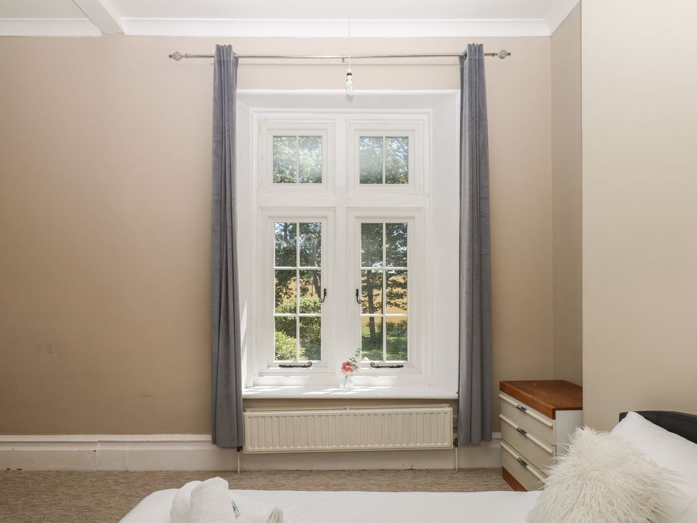A bedroom with a window and drawer unit at Alston Hall near Mothecombe Beach