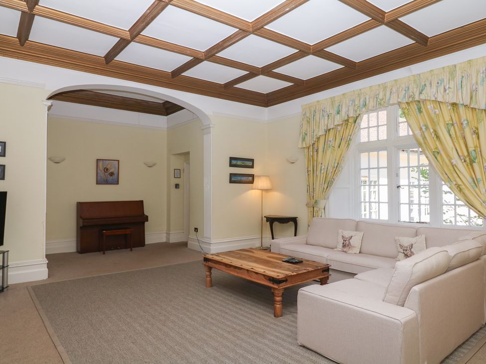 A living room with a sofa and coffee table at Alston Hall near Mothecombe Beach